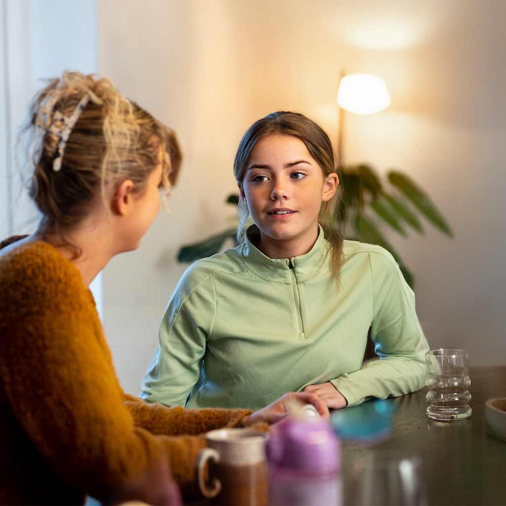 A parent talking to her daughter